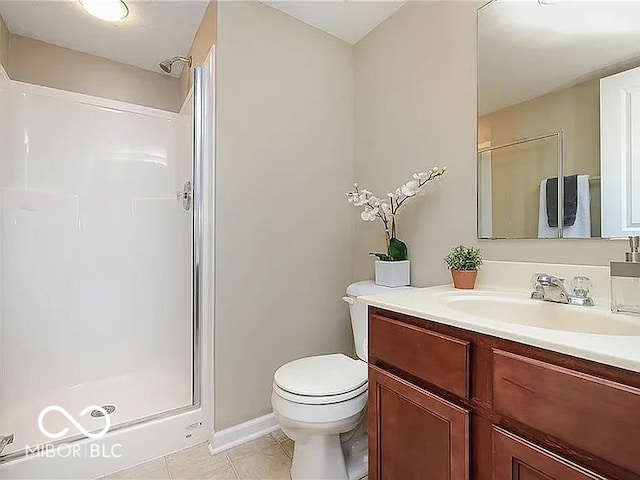 bathroom with vanity, tile patterned flooring, a shower stall, and toilet