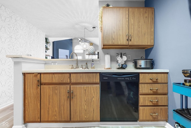 kitchen featuring brown cabinetry, black dishwasher, and light countertops