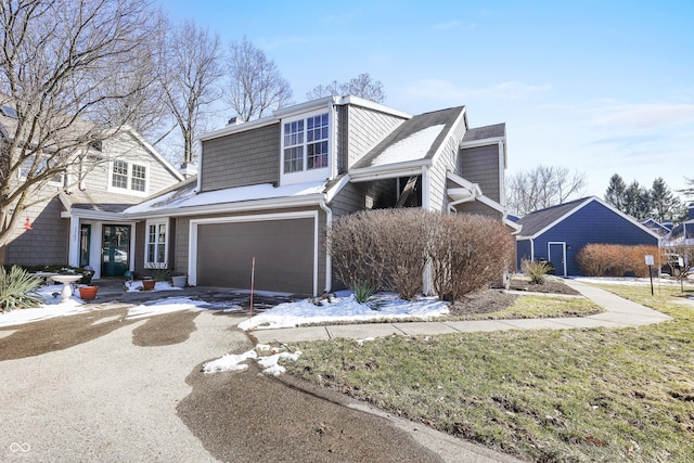 view of front facade featuring an attached garage and aphalt driveway