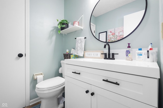 bathroom with toilet and vanity