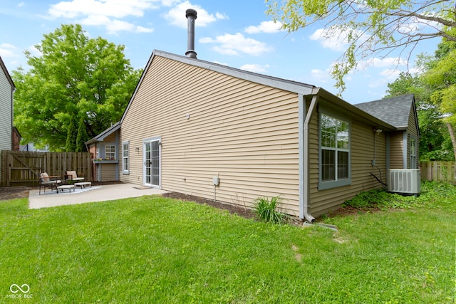 rear view of property with central AC unit, a patio area, and roof with shingles