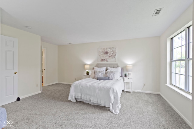 carpeted bedroom with multiple windows and baseboards