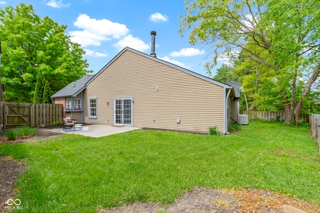 rear view of house featuring a patio area, central AC, and a shingled roof