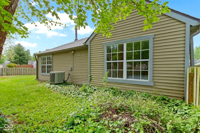 back of house with central AC unit