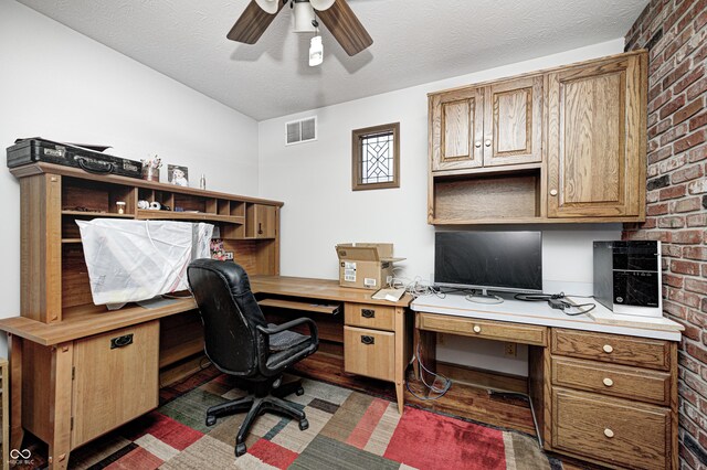 690 N 600 W, Lebanon, IN 46052 - home office featuring a textured ceiling, ceiling fan, brick wall, visible vents, and built in desk