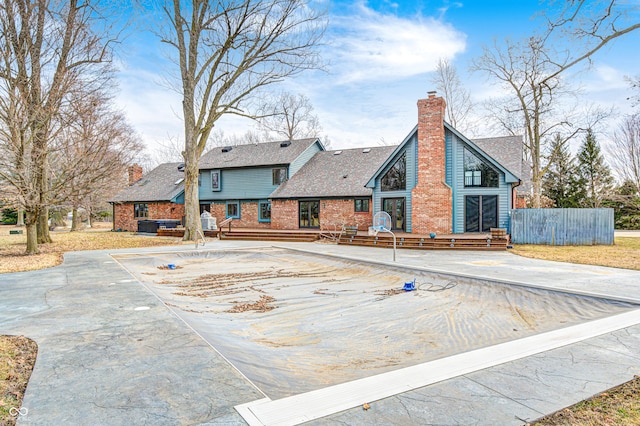 690 N 600 W, Lebanon, IN 46052 - rear view of property featuring brick siding, a chimney, and fence