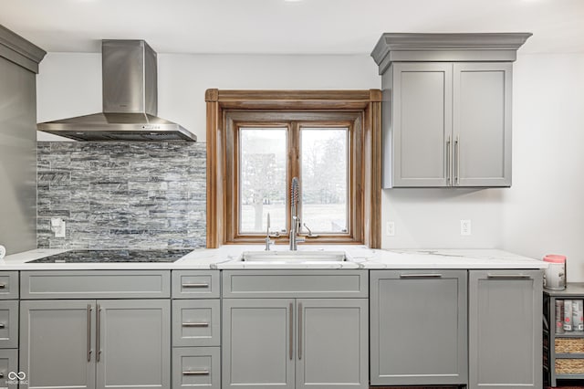 690 N 600 W, Lebanon, IN 46052 - kitchen featuring black electric stovetop, light stone countertops, gray cabinetry, wall chimney range hood, and decorative backsplash