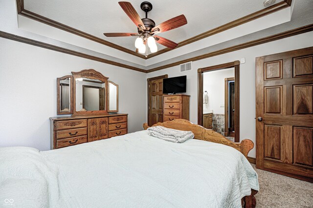 690 N 600 W, Lebanon, IN 46052 - carpeted bedroom featuring visible vents, ensuite bath, ceiling fan, ornamental molding, and a tray ceiling