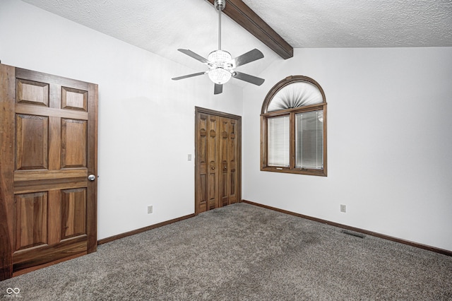 690 N 600 W, Lebanon, IN 46052 - unfurnished bedroom featuring baseboards, visible vents, vaulted ceiling with beams, a textured ceiling, and carpet flooring