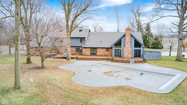 690 N 600 W, Lebanon, IN 46052 - back of property with a patio area, brick siding, a chimney, and a wooden deck