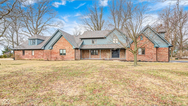 view of front of property with a front lawn and brick siding