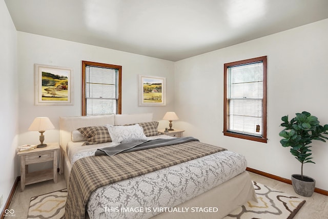 bedroom with carpet floors and baseboards