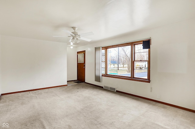 empty room featuring baseboards, visible vents, and carpet flooring