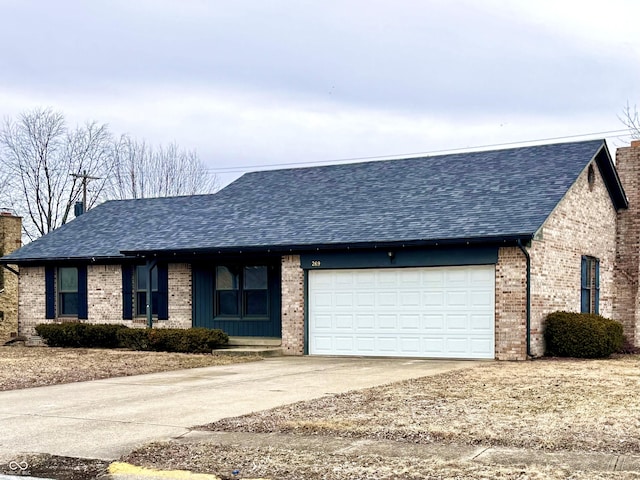 view of front facade featuring a garage, brick siding, a chimney, and roof with shingles