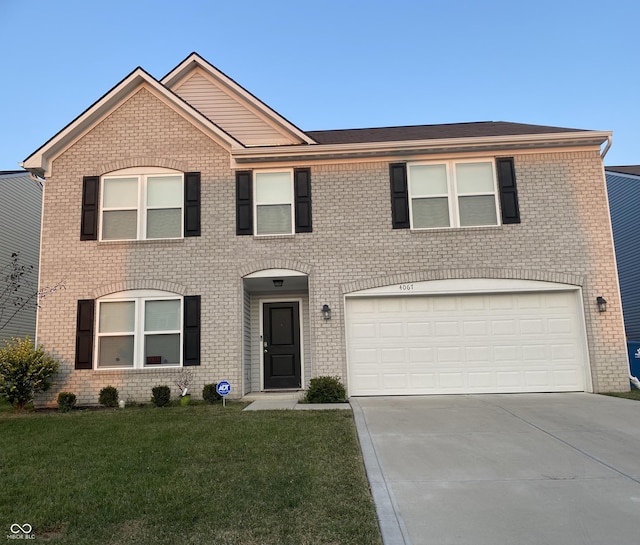 view of front of house with a front yard, concrete driveway, and brick siding