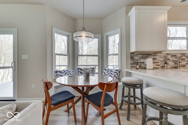 dining space featuring light wood-type flooring and visible vents