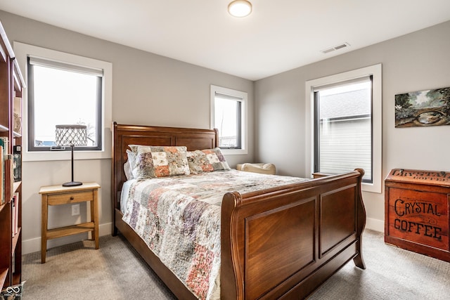 bedroom with light carpet, baseboards, and visible vents