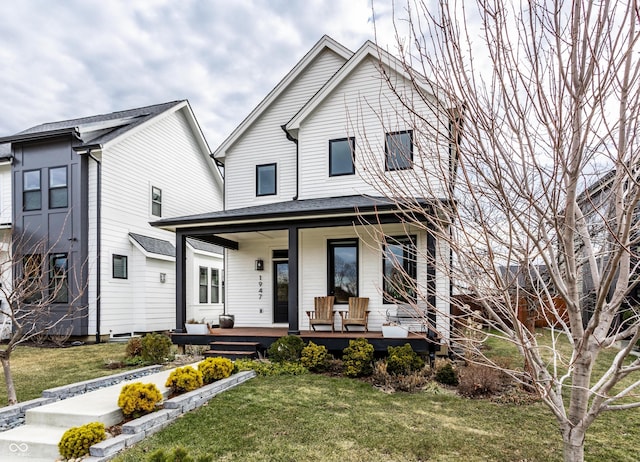 view of front of property with covered porch and a front lawn