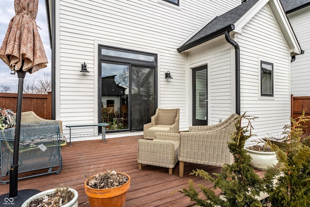 wooden terrace featuring fence