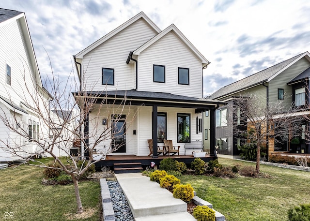 view of front of property with covered porch and a front lawn