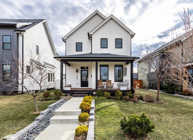 view of front of property with a porch and a front yard