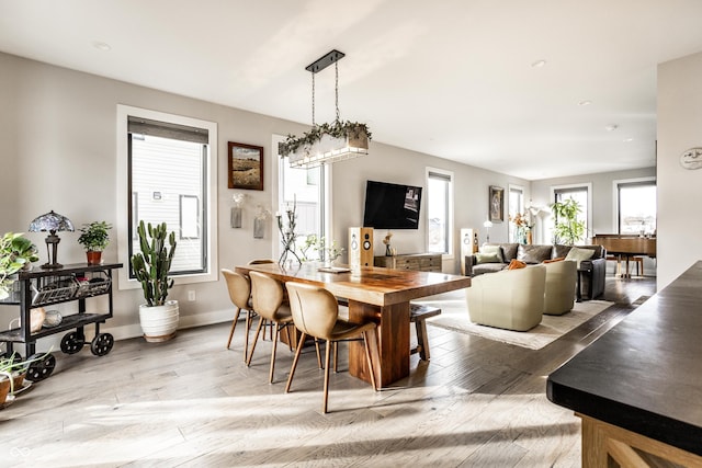 dining room featuring baseboards and light wood finished floors