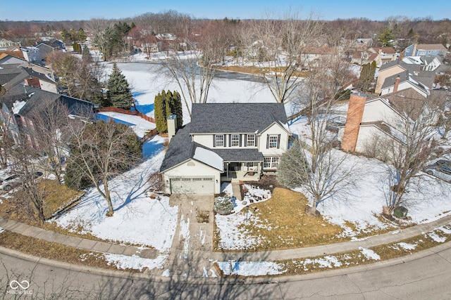 snowy aerial view with a residential view