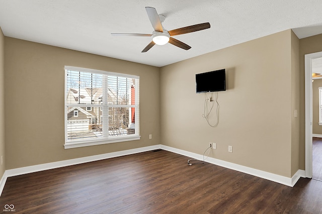 interior space with ceiling fan, baseboards, and dark wood-type flooring