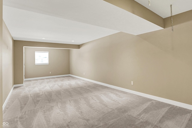 spare room with light colored carpet and baseboards