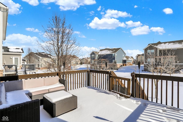 snow covered deck featuring a residential view and an outdoor living space