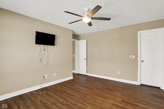 unfurnished living room with dark wood finished floors, baseboards, and ceiling fan