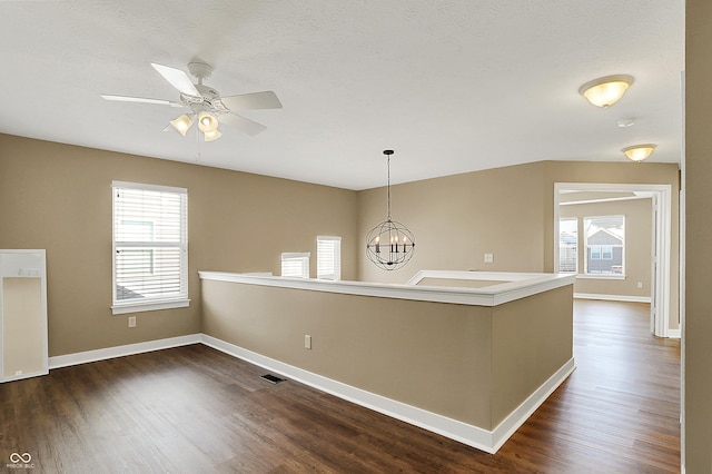 kitchen featuring baseboards, visible vents, pendant lighting, and dark wood-style flooring