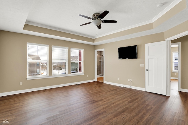 unfurnished room featuring ceiling fan, a textured ceiling, baseboards, dark wood-style floors, and a tray ceiling