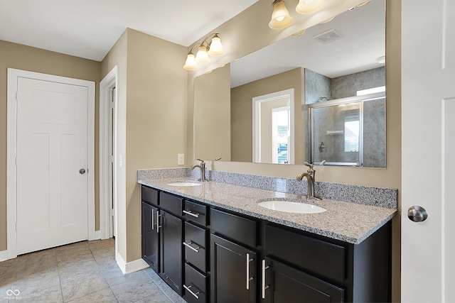 full bath featuring double vanity, a stall shower, a sink, and visible vents