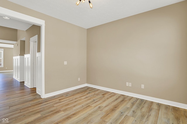 empty room featuring baseboards and wood finished floors