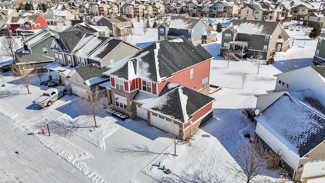 snowy aerial view featuring a residential view