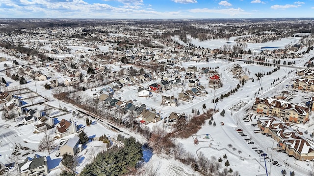 snowy aerial view with a residential view