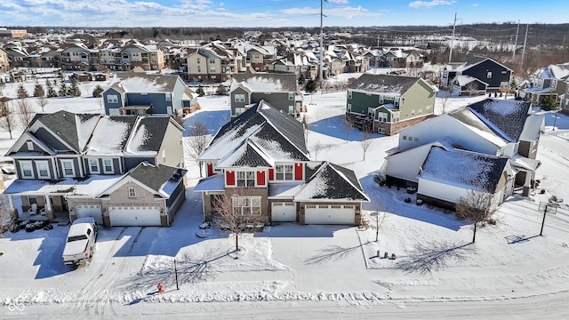 snowy aerial view with a residential view