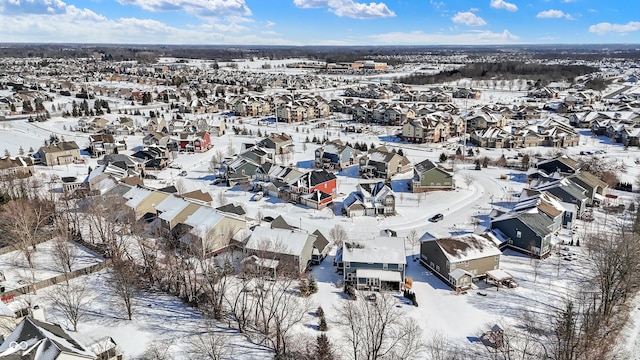 snowy aerial view featuring a residential view