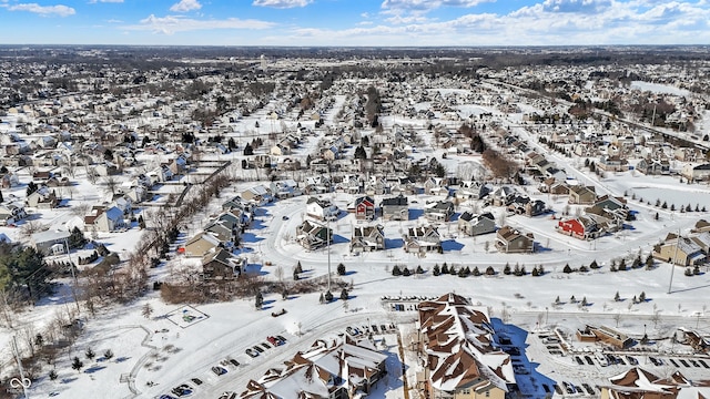 snowy aerial view with a residential view