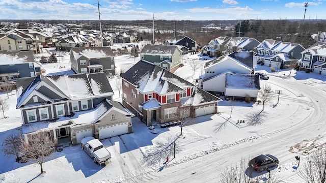 snowy aerial view featuring a residential view