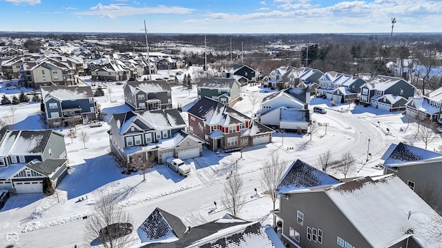 snowy aerial view with a residential view