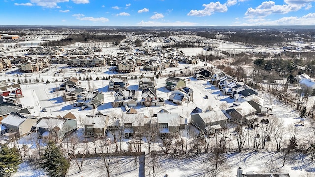 snowy aerial view with a residential view