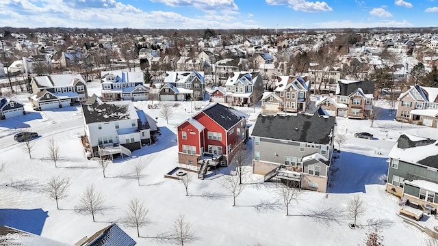 snowy aerial view featuring a residential view