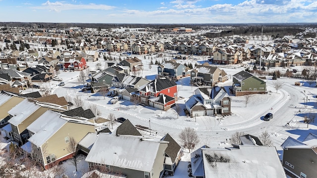 snowy aerial view with a residential view