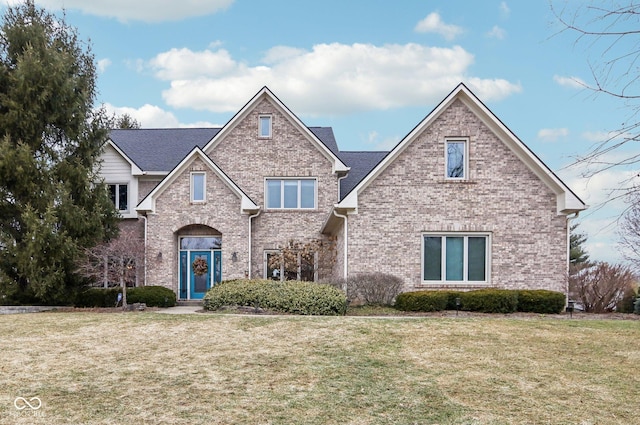 traditional home with brick siding and a front yard