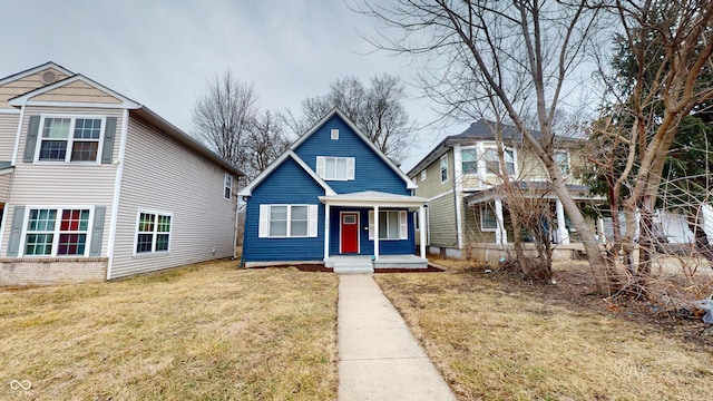 view of front of home with a front yard and covered porch