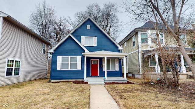 bungalow-style home with a front lawn and a porch