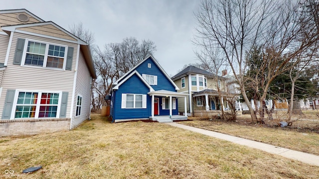 traditional-style house with covered porch and a front yard