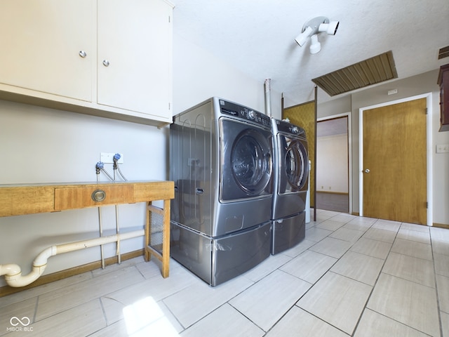 clothes washing area with cabinet space, independent washer and dryer, and visible vents